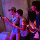 A group on their phone plays a bounty-hunting game at Star Wars: Galaxy's Edge.
